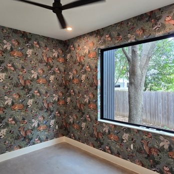 Finished room with floral wallpaper and soft seating